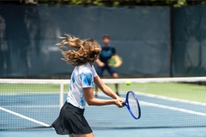 two people playing tennis on a court